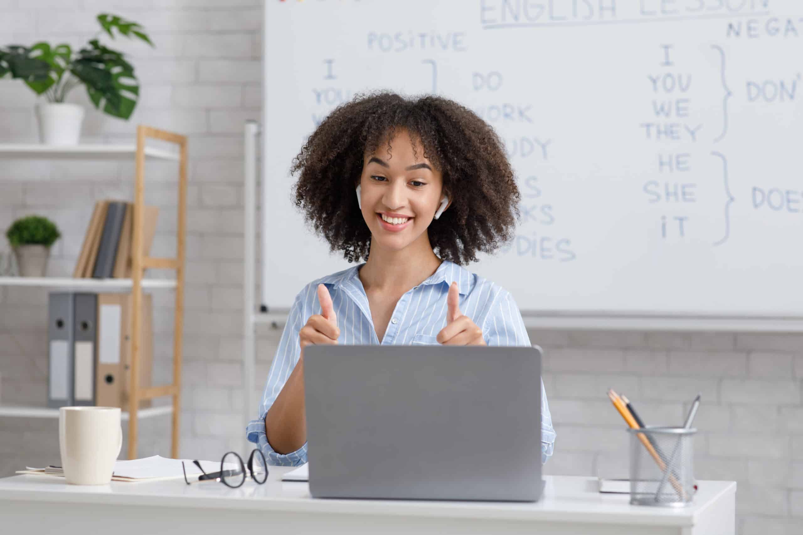 Blogging - girl in a blue shirt sitting at her desktop